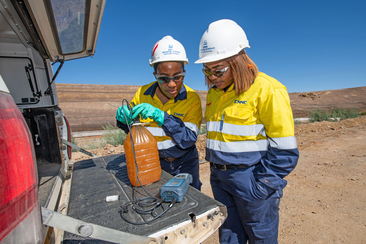 Two workers looking at water samples at Rossing Uranium mine